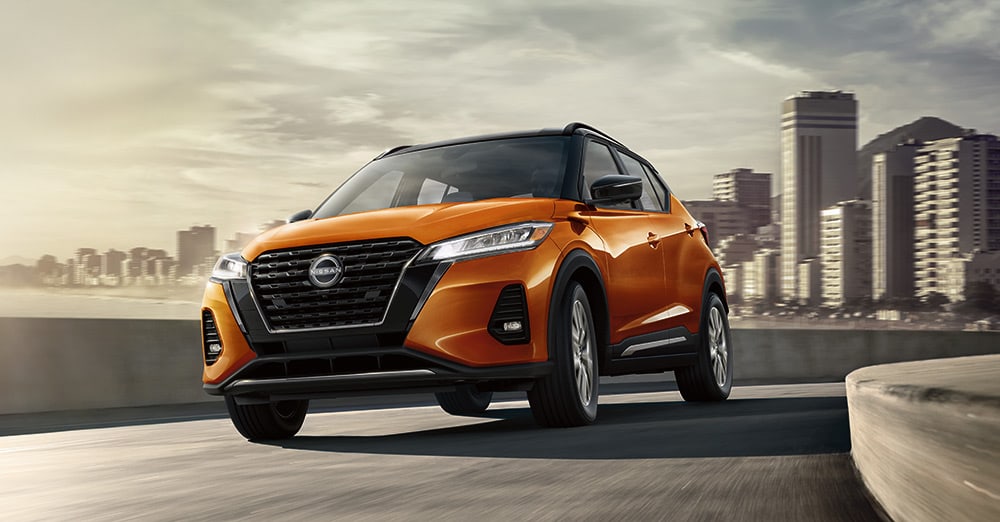 2023 Nissan Kicks driving away from a city skyline