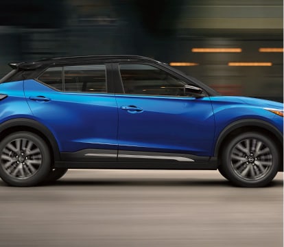 2023 Nissan Kicks driving in the city at night