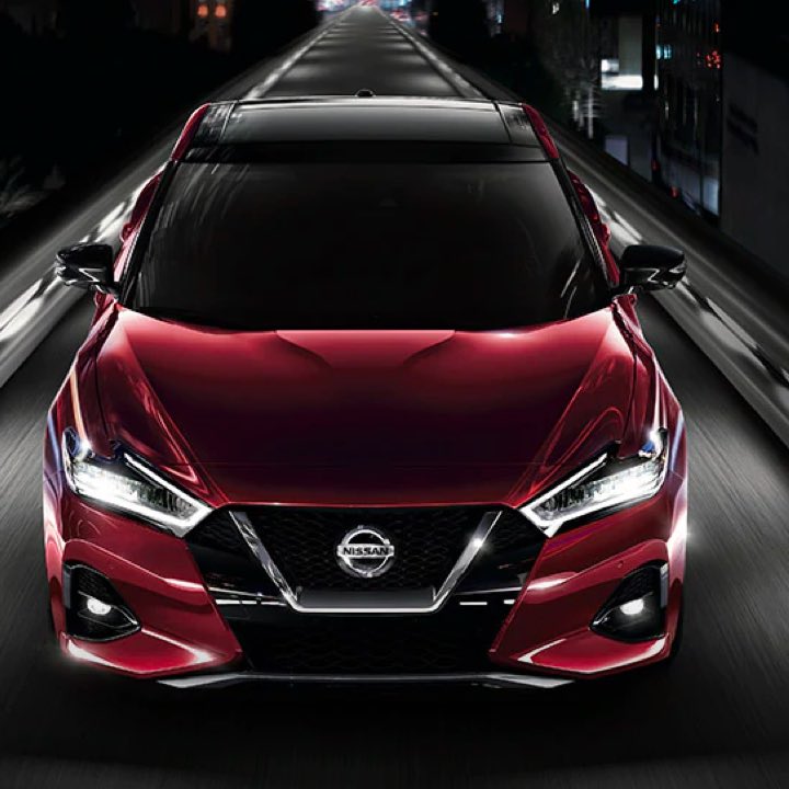 2021 Nissan Maxima in Carnelian Red Tintcoat driving at night