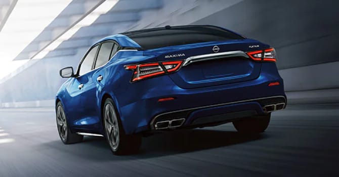 Blue Nissan Maxima driving