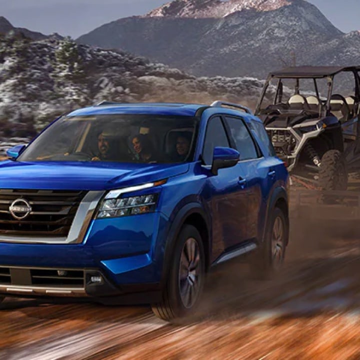 2022 Nissan Pathfinder towing a trailer in the mountains