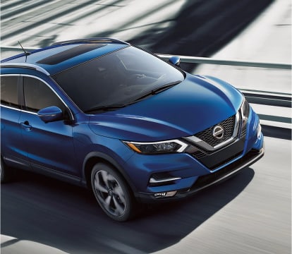 Blue Nissan Rogue Sport driving on the highway