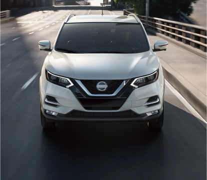 front view of a Rogue Sport driving in a city
