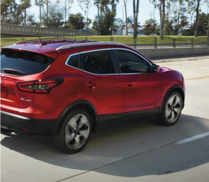 rear 3/4 view of a red Rogue Sport