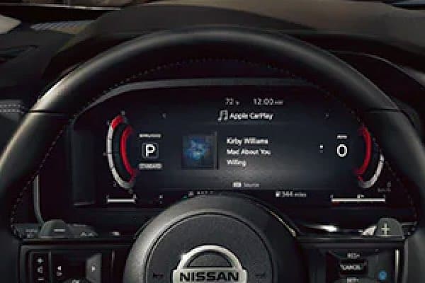 Close up of digital display behind steering wheel