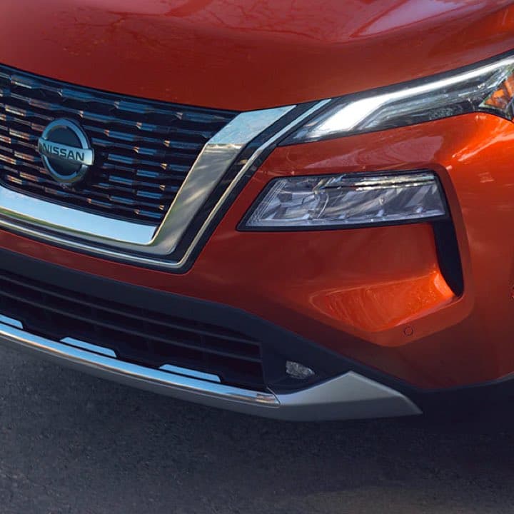 Close-up of Nissan Rogue headlights and grill