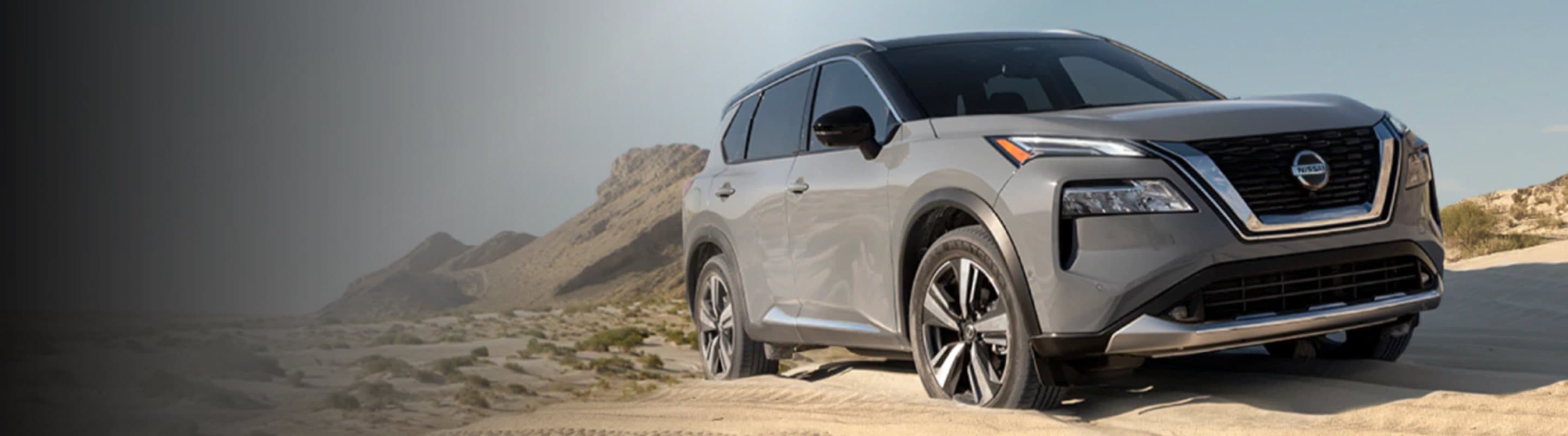 A Nissan Rogue driving over rough terrain