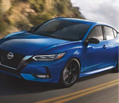 Blue Nissan Sentra driving on road