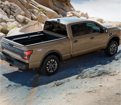 2023 Nissan Titan XD off-roading up a desert hill