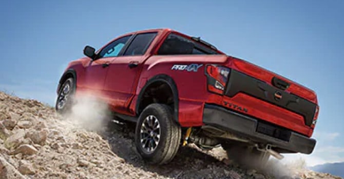 2022 Nissan Titan climbing a sandy hill