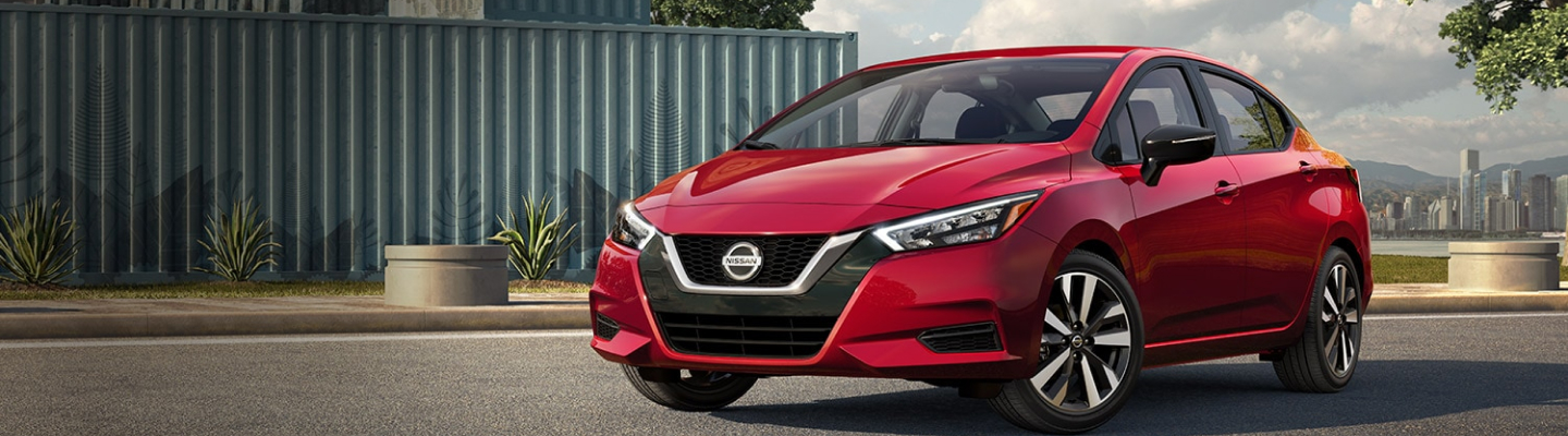 Three quarter view of red Nissan Versa