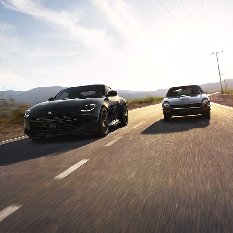 2027 Nissan Z driving next to a 1969 Nissan Z