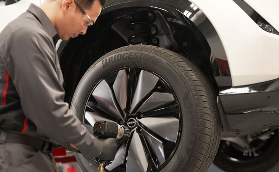 Man working on vehicle.