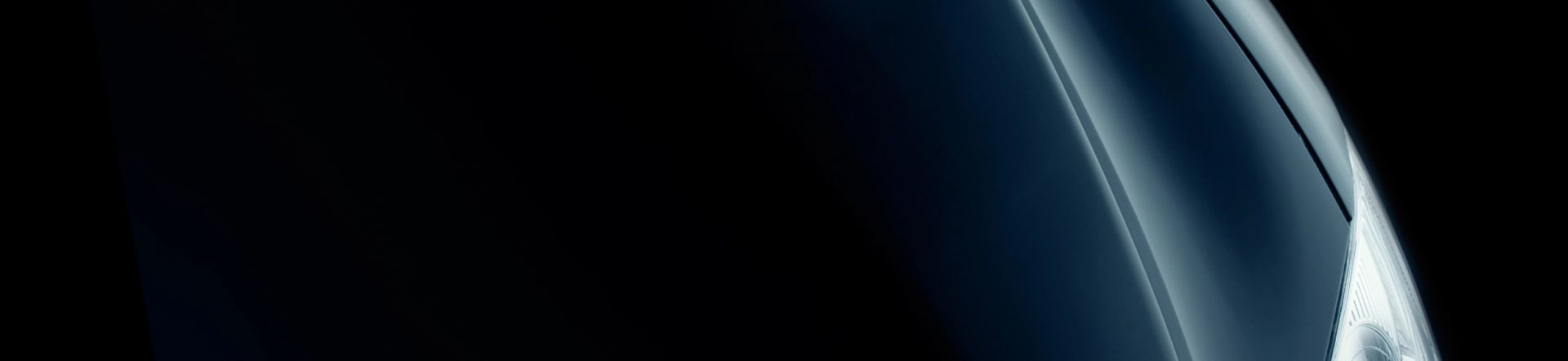 Dark background with a silhouette of a black car