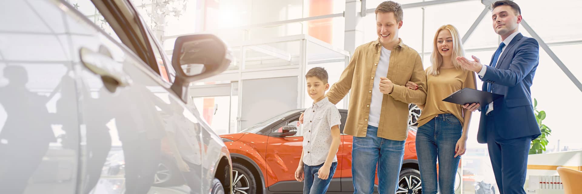 family looking at vehicle with salesperson
