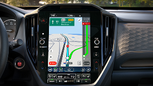 An in-dash Subaru Multimedia touchscreen displaying a Subaru Navigation real-time map