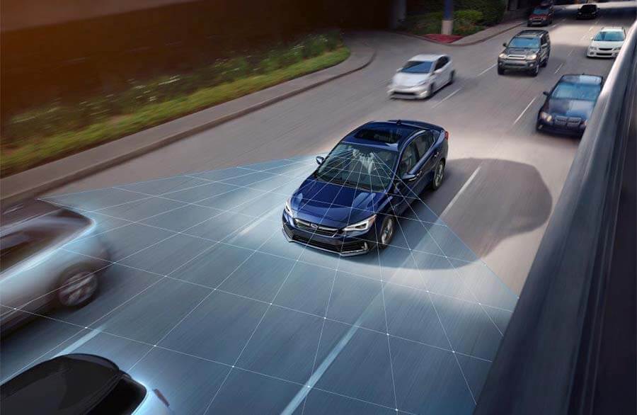 A blue Subaru in a center lane with three cars in front and a blue field from the Subaru's front.