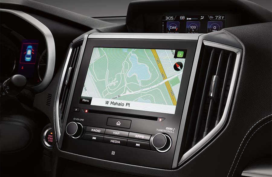 A person's finger touching the Subaru navigation screen.