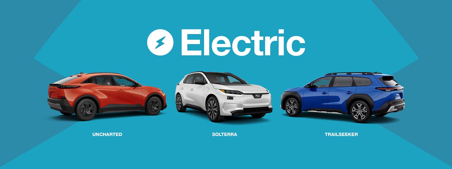 Three Subaru electric vehicles displayed on a blue background with the word ‘Electric’ and a lightning bolt icon above them. From left to right: a red Subaru Uncharted, a white Subaru Solterra, and a blue Subaru Trailseeker.