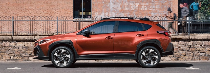 Subaru Crosstrek parked next to a brick building