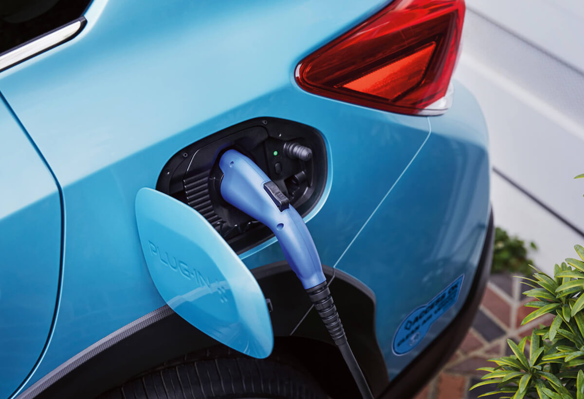 A close-up of the Subaru Crosstrek Hybrid’s charging port with charging cable plugged in