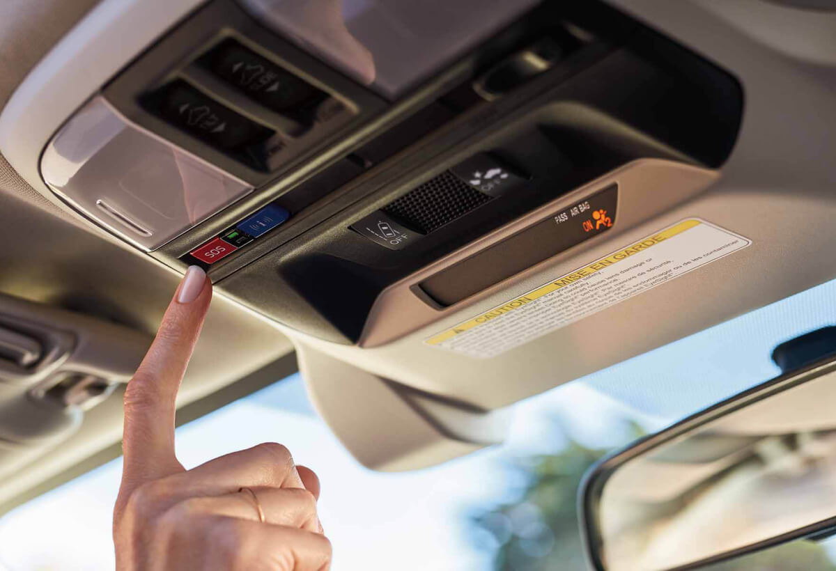 A finger pressing the Crosstrek Hybrid’s SOS emergency assistance button