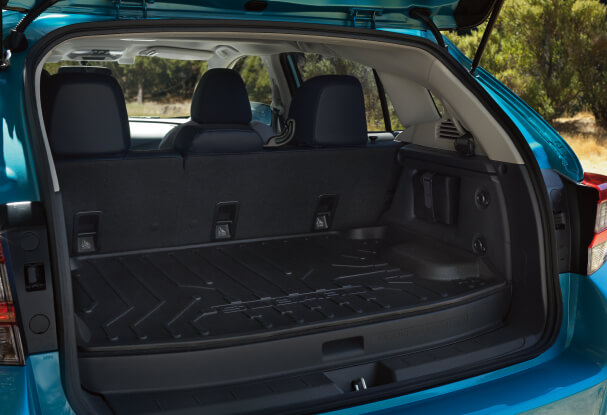 An exterior view of the rear cargo area of the 2023 Crosstrek Hybrid with the rear seatbacks folded down.