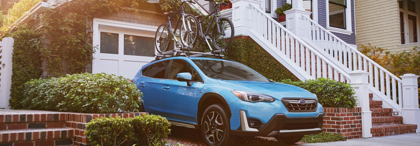 A 2023 Crosstrek Hybrid parked in a driveway.