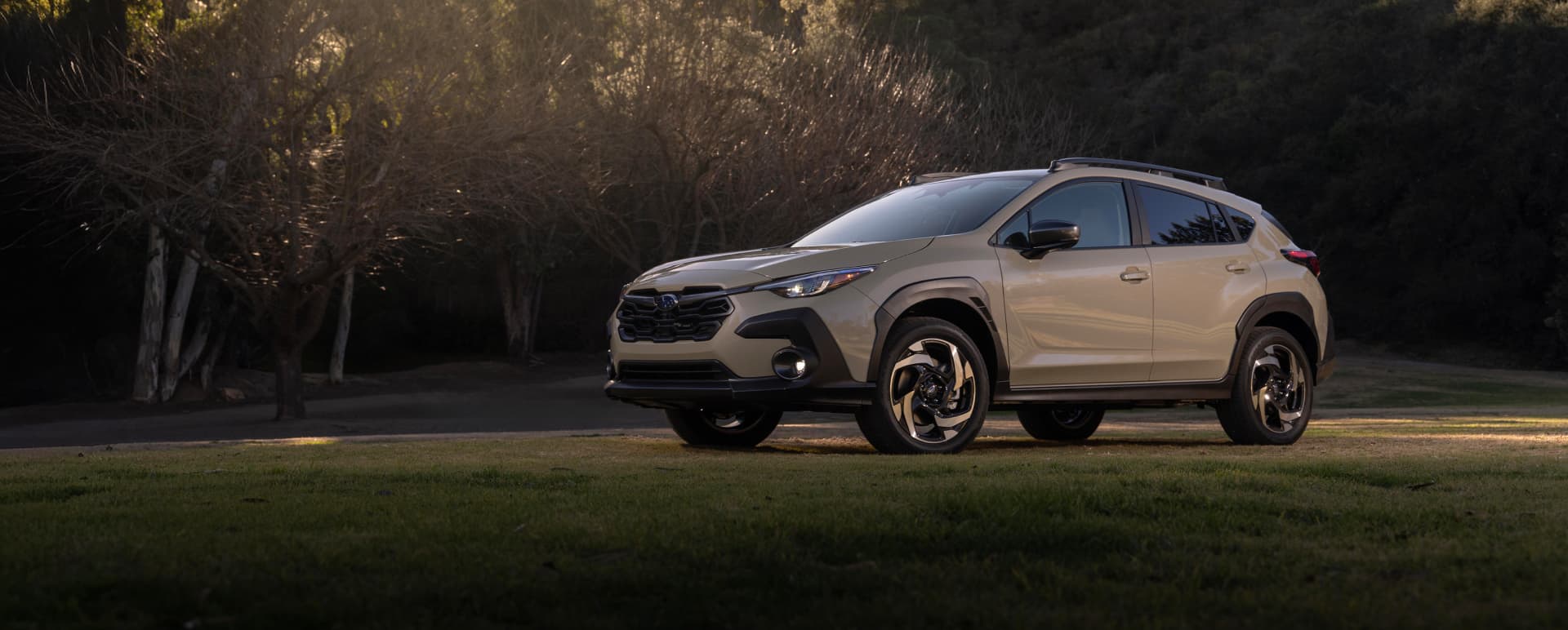 2027 Crosstrek Hybrid parked in a hilly, tree-covered landscape.