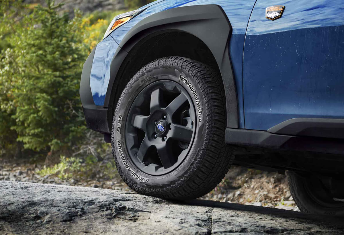 A close-up of the wheels of the 2022 Outback Wilderness showing the 9.5 inches of ground clearance.