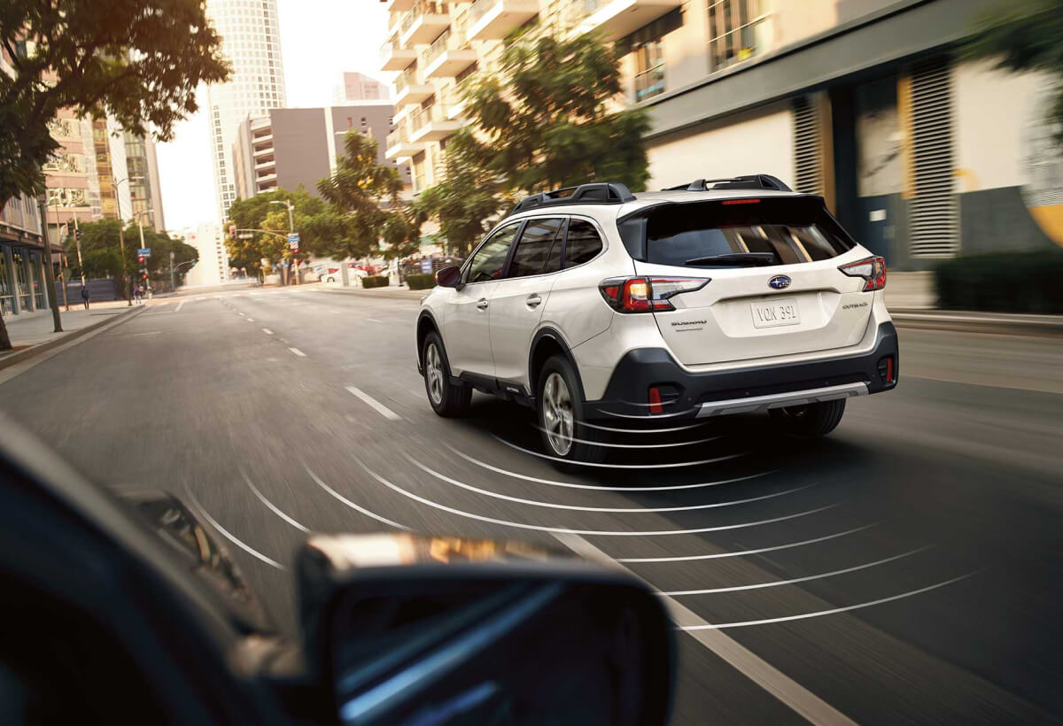 A 2022 Subaru Outback driving on a city street.