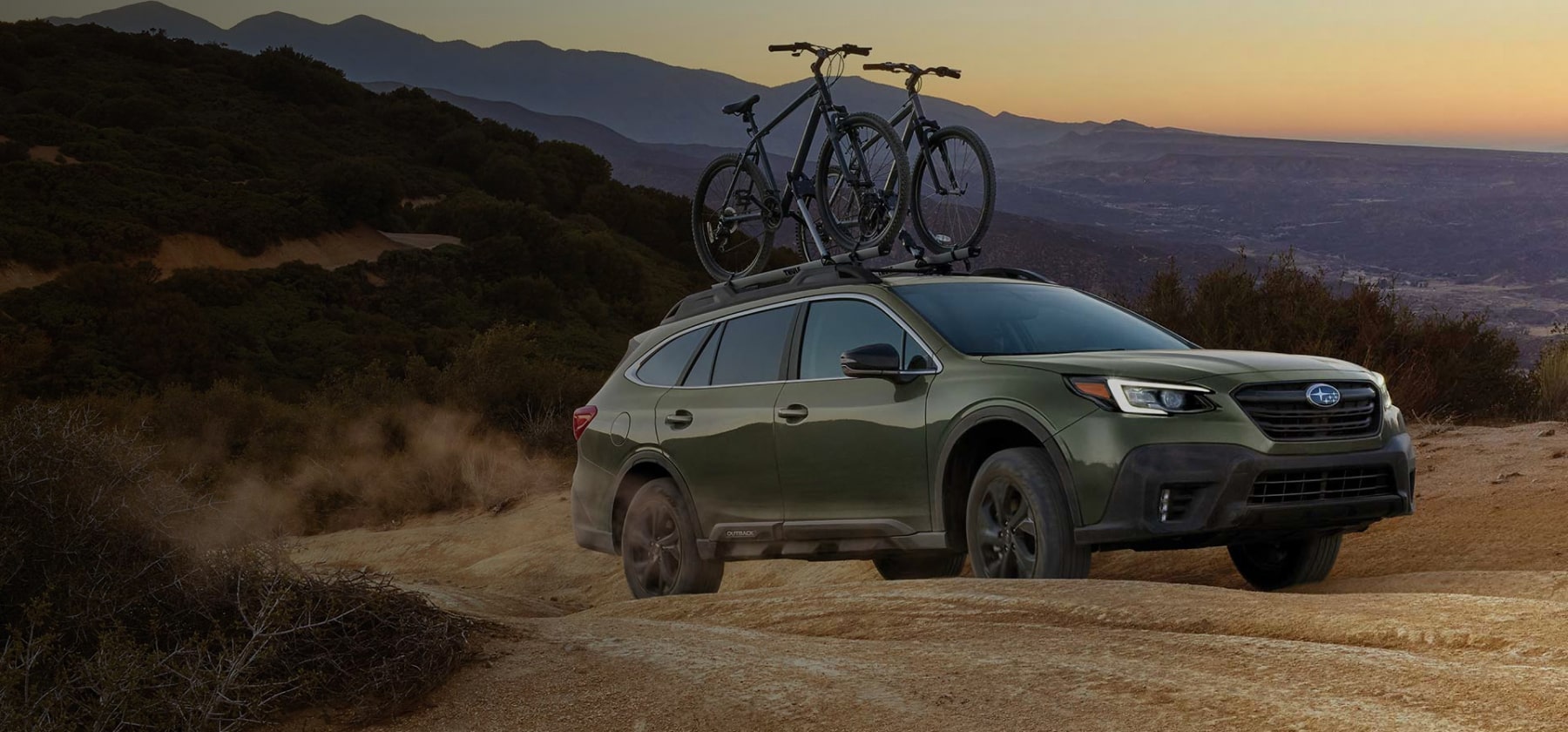 A 2022 Subaru Onyx Edition XT driving on a dirt road in the mountains.