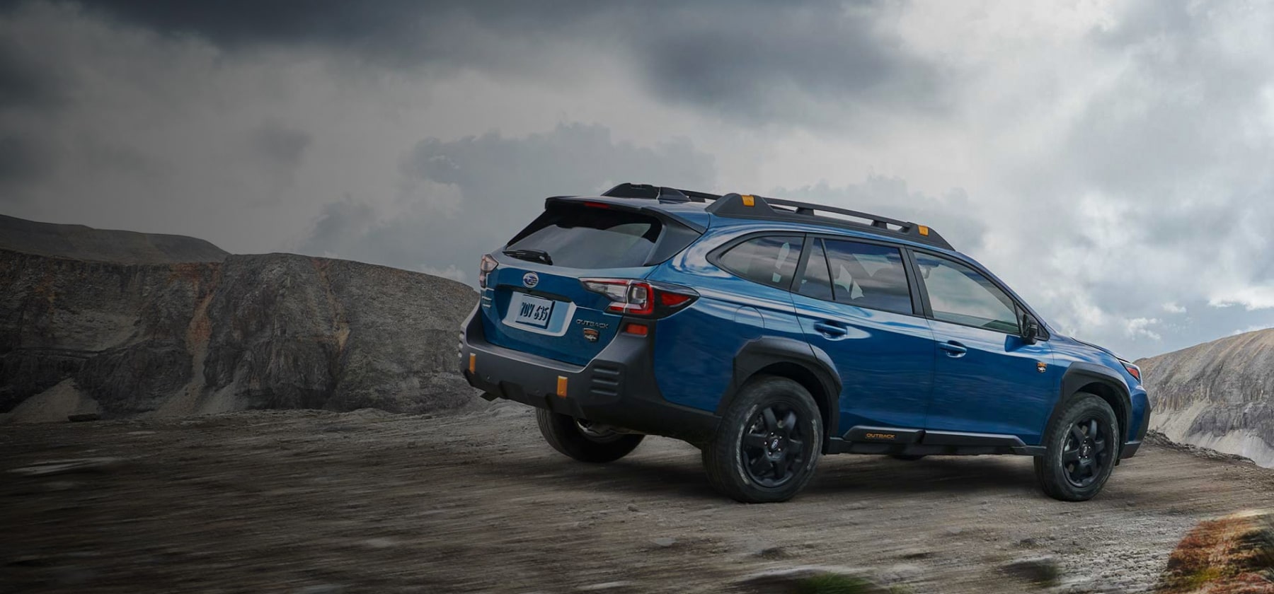 2022 Subaru Outback Wilderness driving down a rocky incline. 