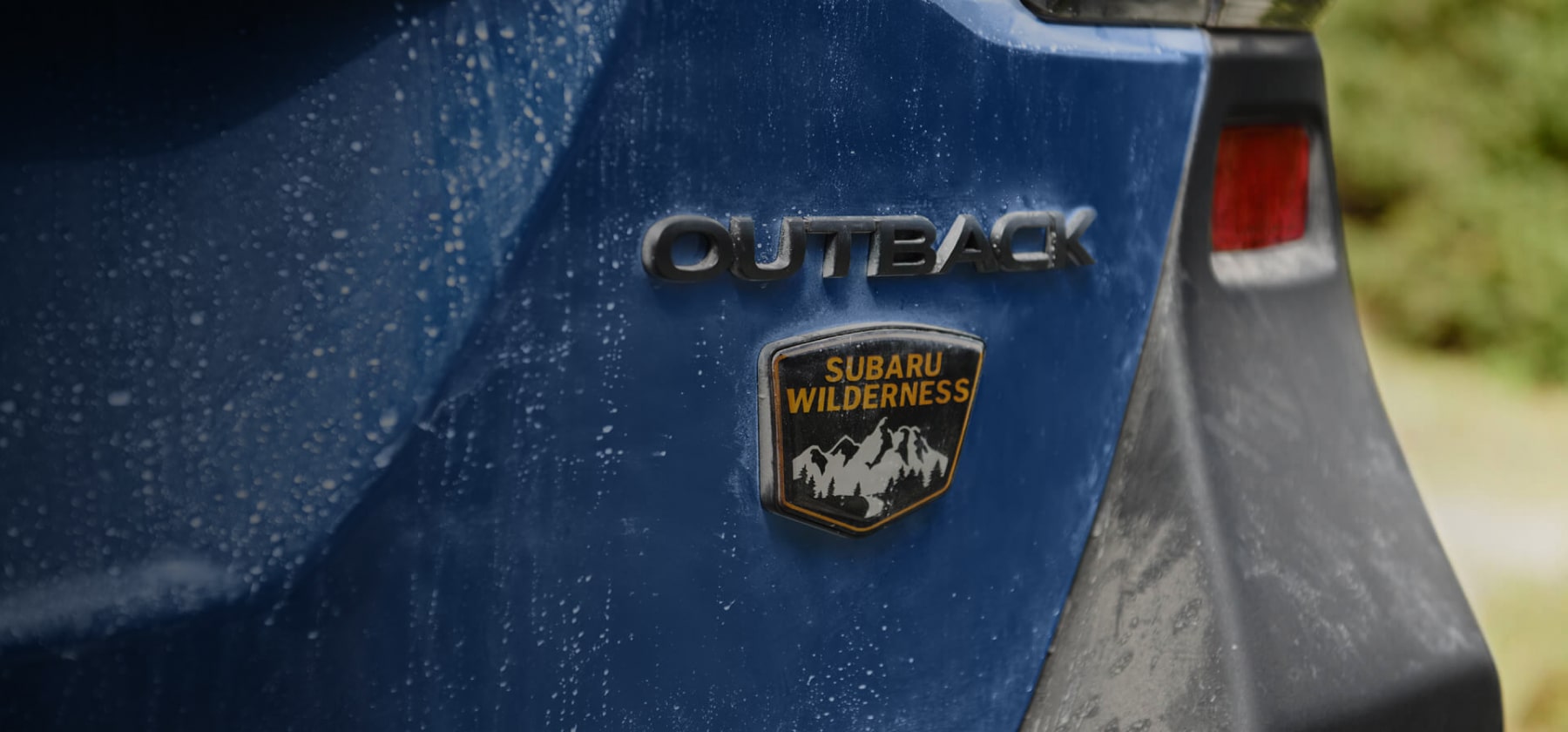 A close up of the 2022 Subaru Outback Wilderness badge on the back bumper. 