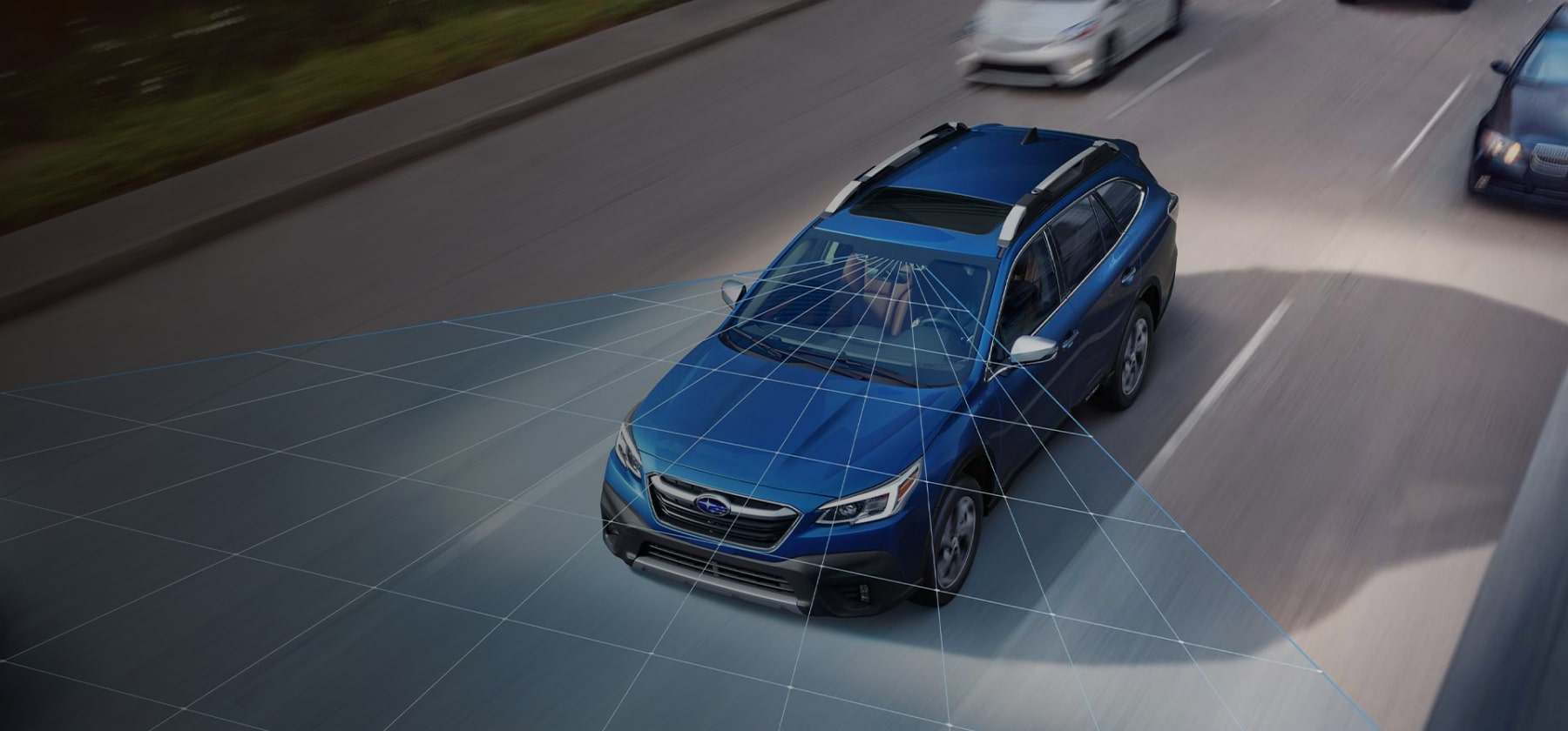A photo illustration showing the EyeSight® Driver Assist Technology sensors on a 2022 Subaru Outback driving down a highway.
