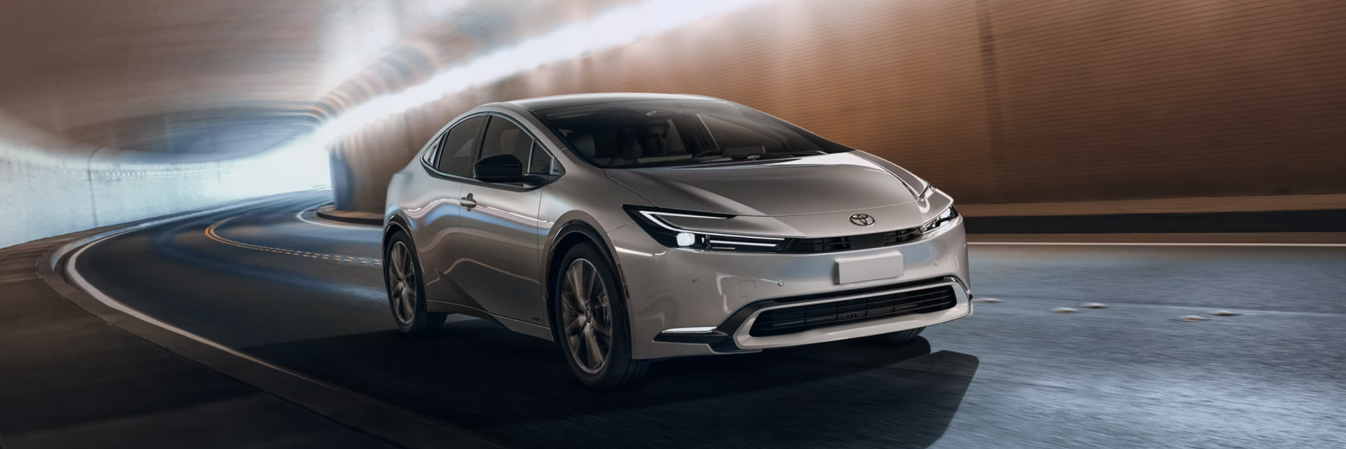 2027 Prius driving towards the viewer in an underground tunnel