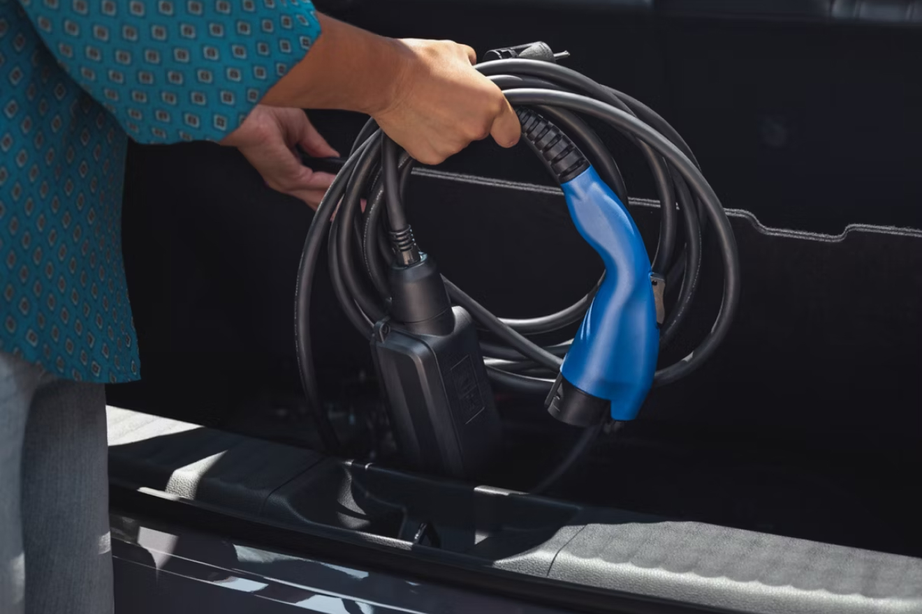Close up of hands stowing charging equipment into storage