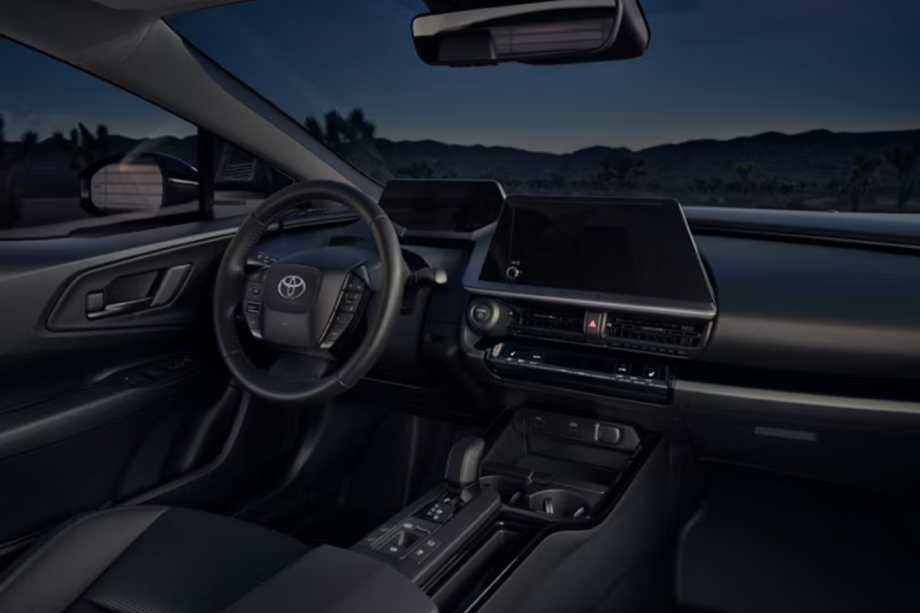 Interior shot of 2027 Prius Plug-In Hybrid's steering column, driver's seat, dashboard, digital interface