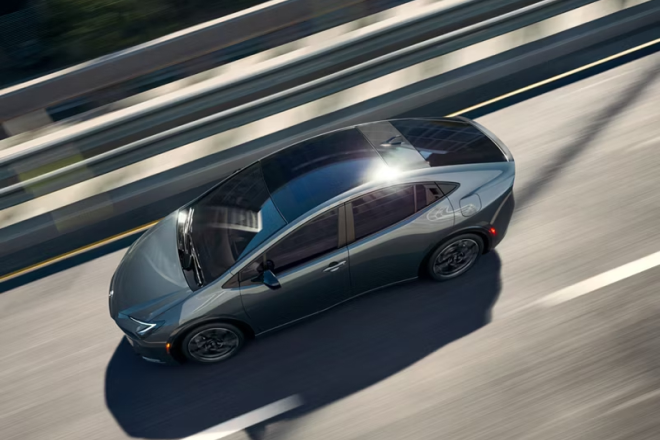 Top view of 2027 Prius Plug-in Hybrid driving on a road