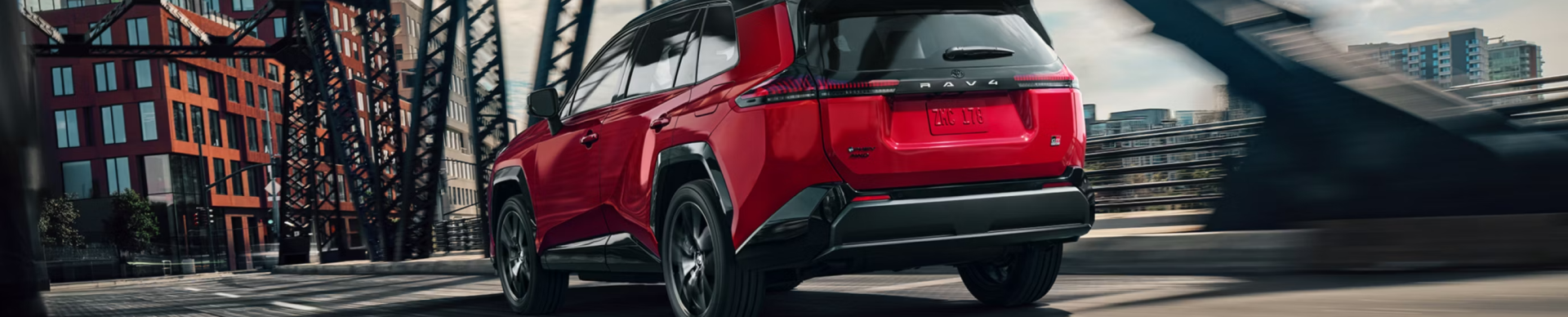RAV4Plug-inHybrid Red Driving on Road