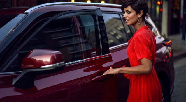 Woman in red dress opening driver's side front door