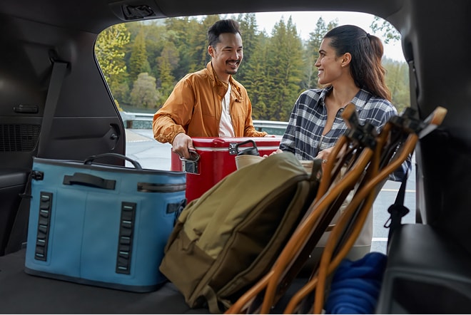 Couple loading cargo into a Toyota SUV