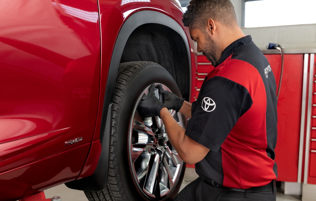 Toyota service technicial replacing a wheel