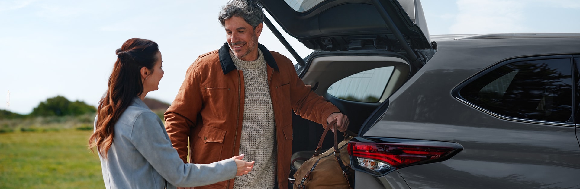 Couple loading the rear of a Toyota Highlander
