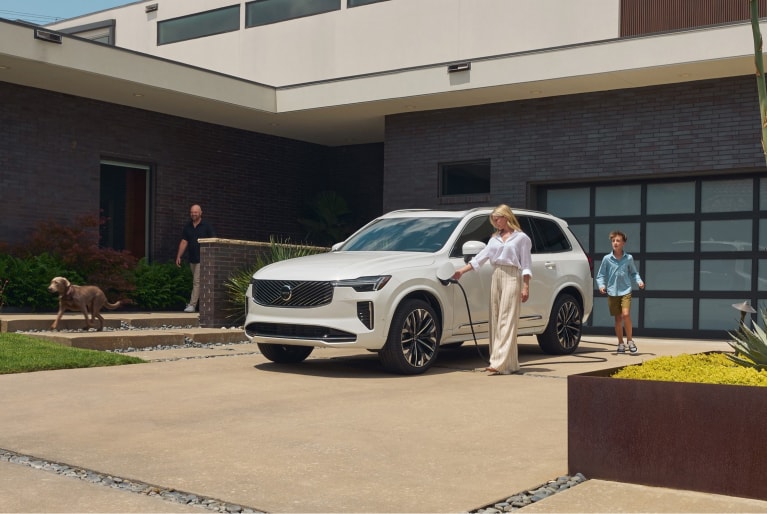 Volvo charging in a suburban driveway