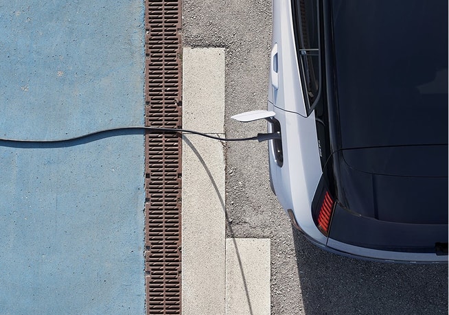 overhead view of a Volvo SUV plugged into an AC charger