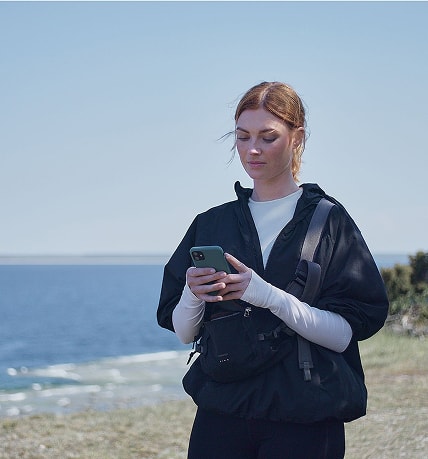 woman using Volvo Cars app on a smartphone