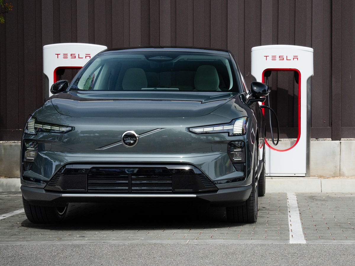 Volvo EX60 charging at a Tesla Supercharger